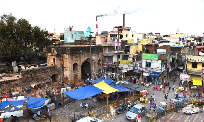 Smoke billows from two smokestacks at the coal-based Badarpur Thermal Station in New Delhi on April 6, 2015. India relies on thermal power plants for 54 percent of its electricity. (MONEY SHARMA/AFP via Getty Images)