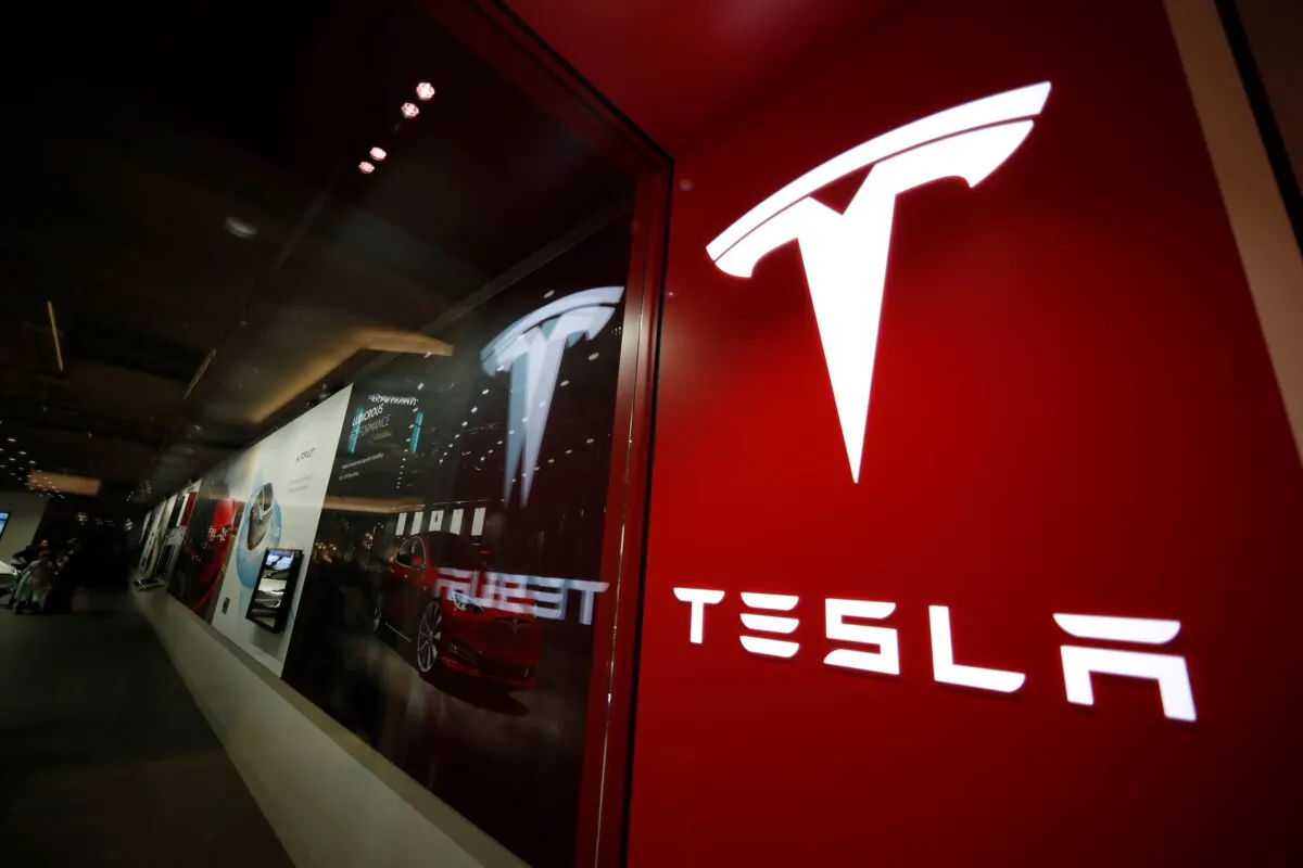 This photo shows a sign bearing the company logo outside a Tesla store in Cherry Creek Mall in Denver, Colo., on Feb. 9, 2019. (David Zalubowski/AP Photo)