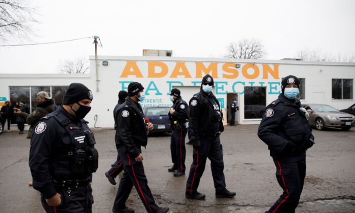 Police stitchery  successful  the parking batch  of Adamson Barbecue, an Etobicoke concern  that has defied provincial shutdown orders, connected  Nov. 25, 2020 successful  Toronto, Canada. (Cole Burston/AFP via Getty Images)