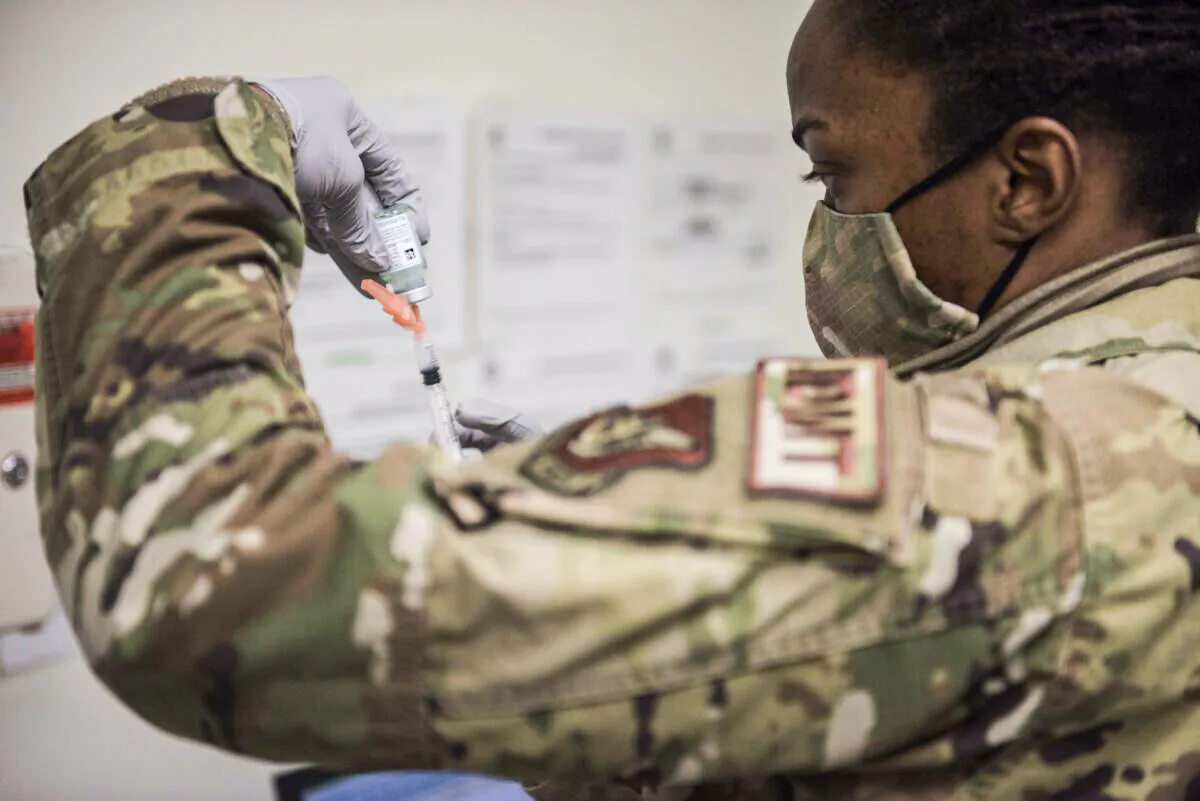 A U.S. Air Force technical sergeant prepares to administer a COVID-19 vaccine at Kunsan Air Base in Kunsan, South Korea. (United States Forces Korea via Getty Images)