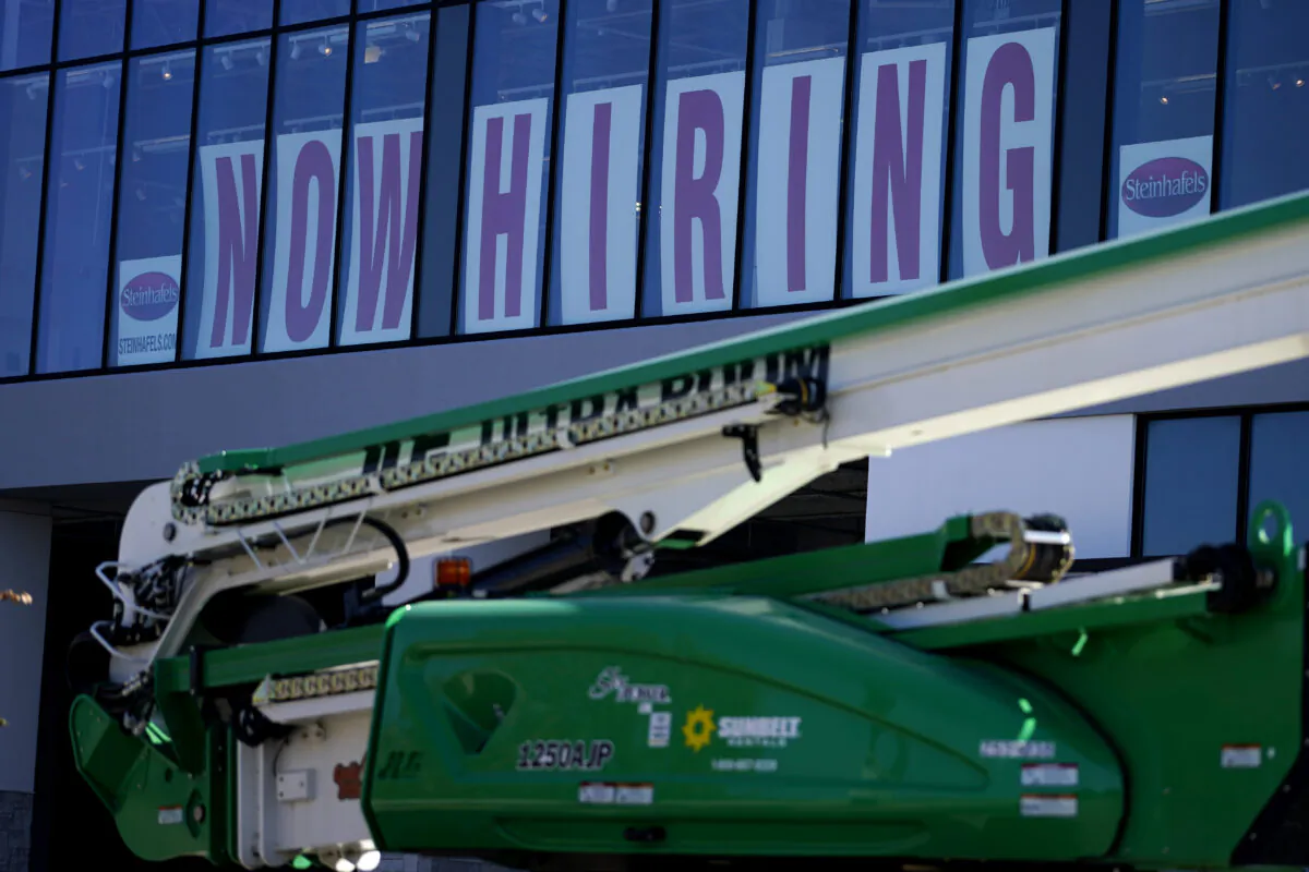 A hiring sign is displayed at a furniture store window in Downers Grove, Ill., on Sept. 17, 2021. (Nam Y. Huh/AP Photo)