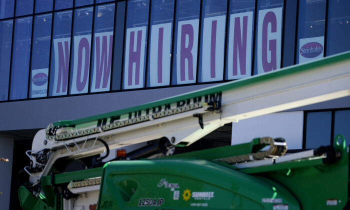 A hiring sign is displayed at a furniture store window in Downers Grove, Ill., on Sept. 17, 2021. (Nam Y. Huh/AP Photo)