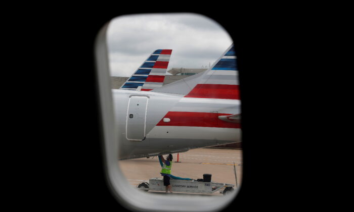An airlines worker works on an American Airlines plane that arrived at Hartsfield–Jackson Atlanta International Airport in Atlanta, Ga. on May 19, 2020. (Shannon Stapleton/Reuters)