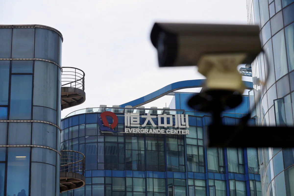 A surveillance camera is seen near the logo of the China Evergrande Group at the Evergrande Center in Shanghai, China, on September 24, 2021. (Aly Song/Reuters)