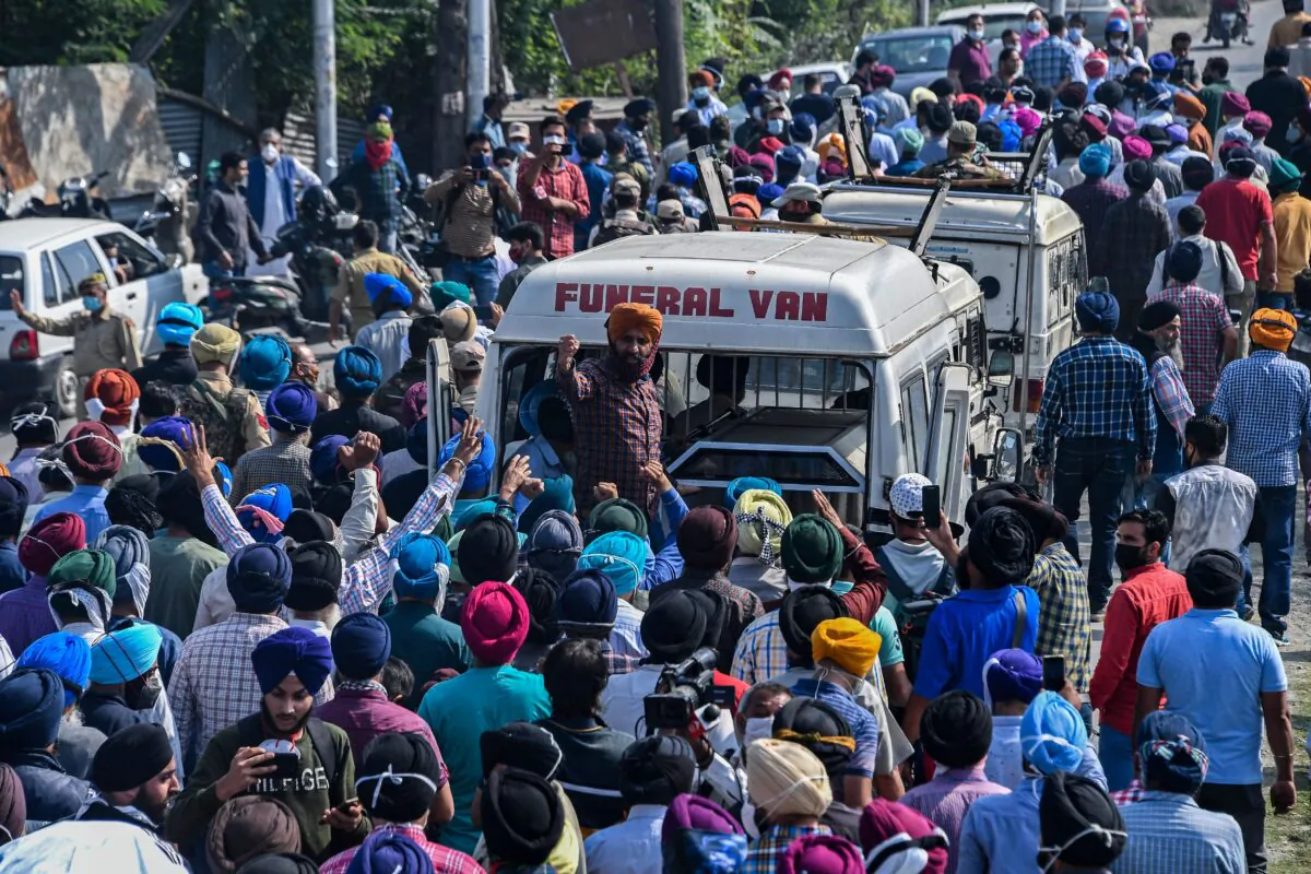 People shout slogans during the funeral procession of slain government school principal Supinder Kour in Srinagar on Oct. 8, 2021, a day after suspected anti-India militants shot dead two school teachers in Indian-administered Kashmir. (Tauseef Mustafa/AFP via Getty Images)
