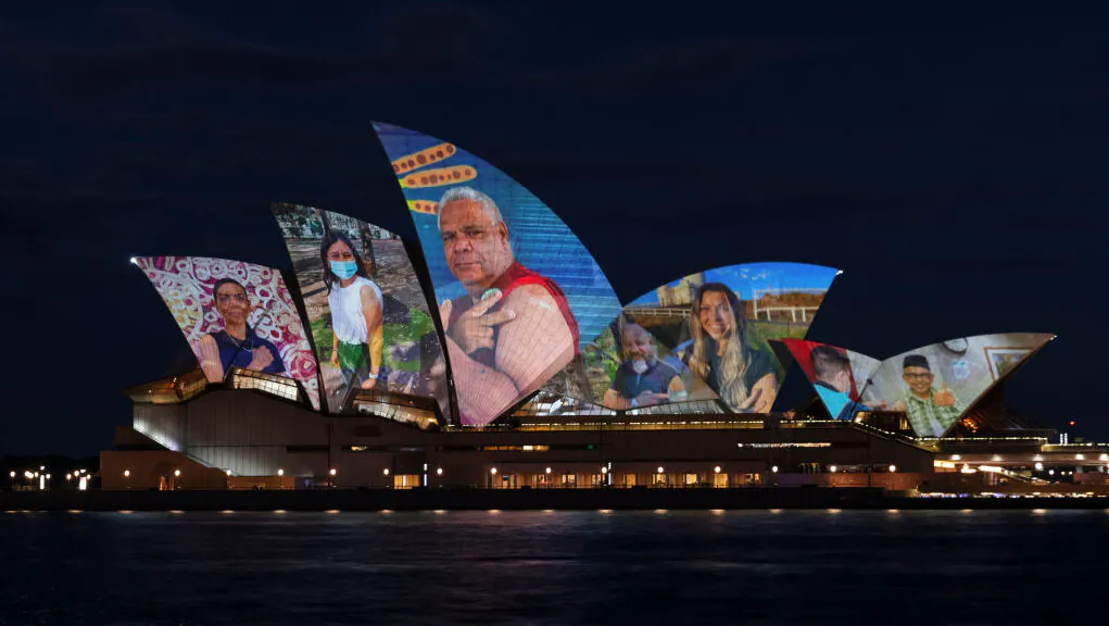 Images of the pandemic are projected onto the Sydney Opera House in Sydney, Australia, on Oct. 18, 2021. (Brook Mitchell/Getty Images)