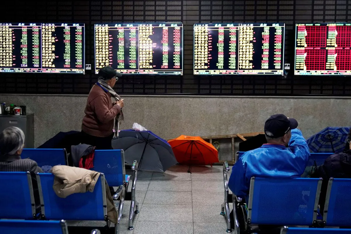 Investors look at screens showing stock information at a brokerage house in Shanghai, China, on Jan. 16, 2020. (Aly Song/Reuters)