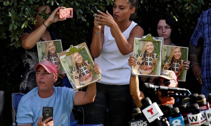 Supporters of Gabby Petito hold up photos of Gabby after a news conference in North Port, Fla., on Oct. 20, 2021. (Chris O'Meara/AP Photo)