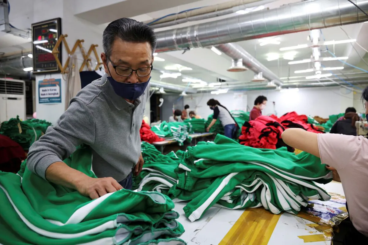 Ko Jong-hyun, 59, a clothing factory owner, checks newly made tracksuits inspired by Netflix series "Squid Game" at his plant in Seoul, South Korea, on Oct. 21, 2021. (Kim Hong-Ji/Reuters)