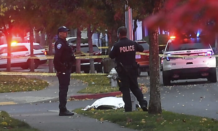 Police basal   by a covered assemblage  astatine  the country   of a shooting successful  Tacoma, Wash., connected  Oct. 21, 2021. (Drew Perine/The News Tribune via AP)