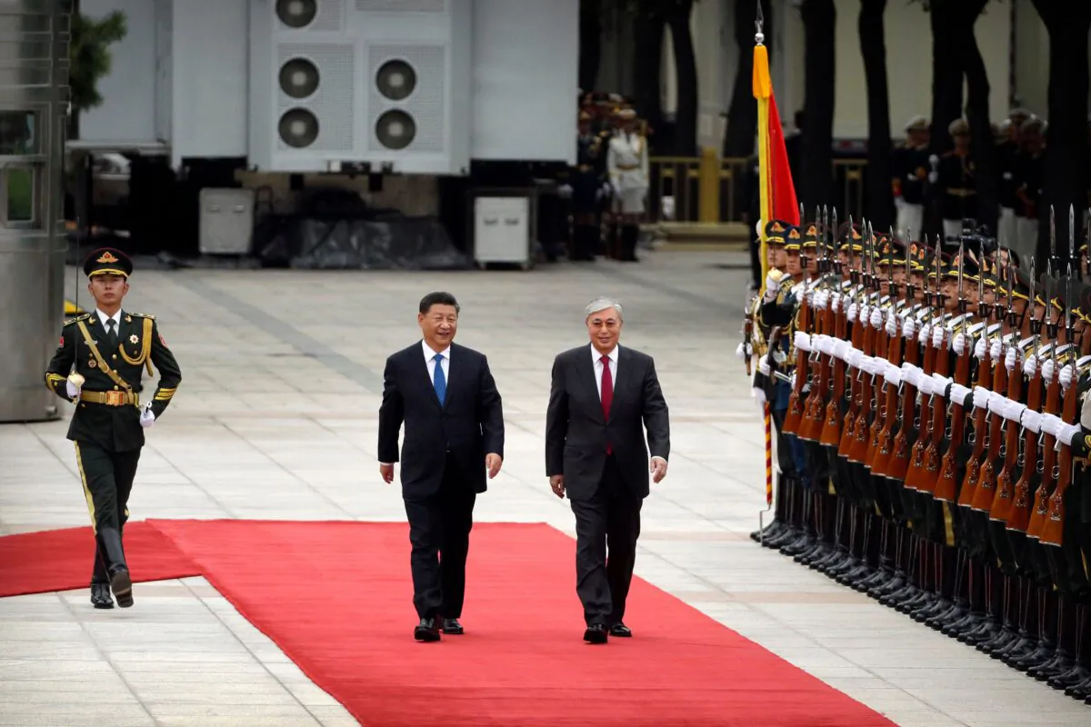 China's President Xi Jinping (L) and Kazakhstan's President Kassym-Jomart Tokayev review an honor guard during a welcoming ceremony at the Great Hall of the People in Beijing on Sept. 11, 2019. (Mark Schiefelbein/AFP via Getty Images)