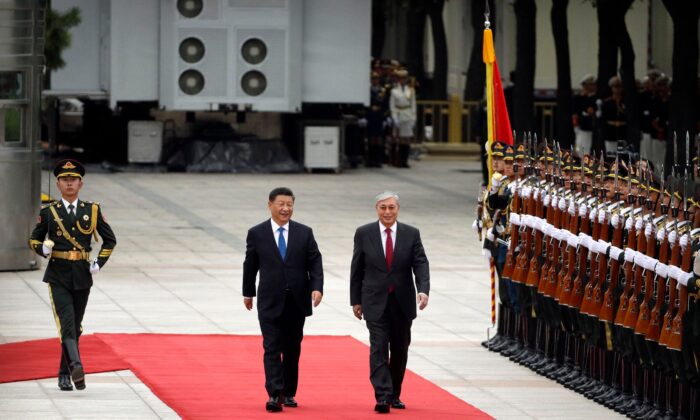 Chinese leader Xi Jinping (left) and Kazakhstan's President Kassym-Jomart Tokayev review an honor guard during a welcoming ceremony at the Great Hall of the People in Beijing on Sept. 11, 2019. (Mark Schiefelbein/AFP via Getty Images)