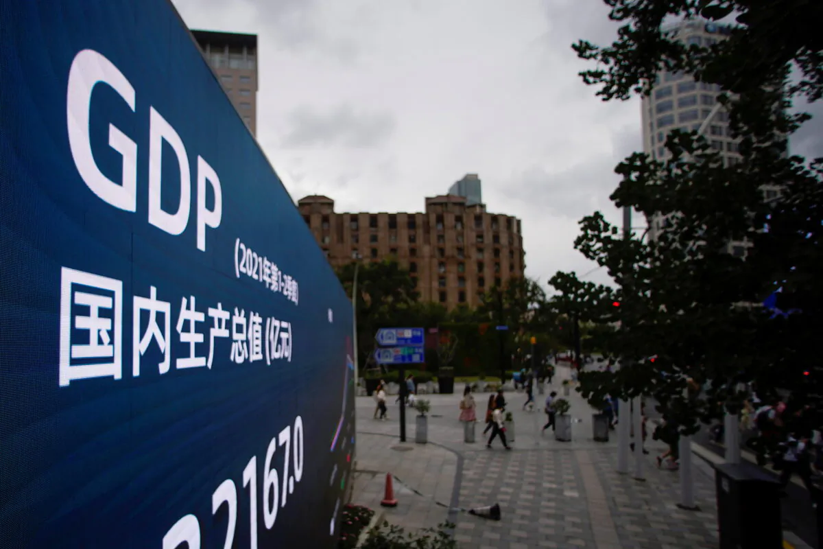 An electronic display showing the China GDP indexes is seen on a street in Shanghai, China, on Oct. 16, 2021. (Aly Song/Reuters)