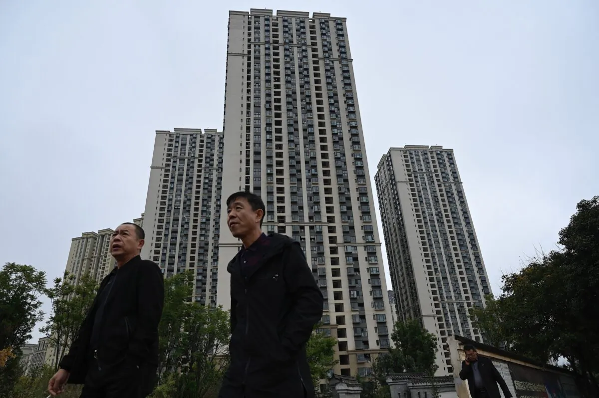 People walk past a housing complex of Chinese property developer Evergrande in Kunming, in southwestern Yunnan Province, on Oct. 23, 2021. (Jade Gao/AFP via Getty Images)