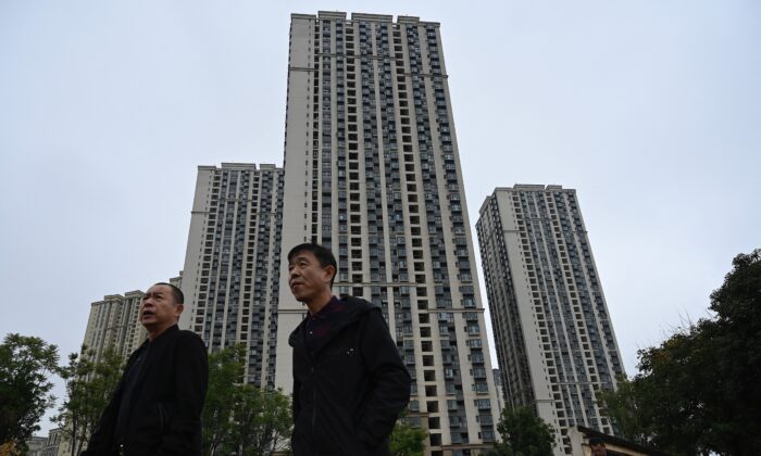 People walk past a housing complex of Chinese property developer Evergrande in Kunming, in southwestern Yunnan Province on Oct. 23, 2021. (Jade Gao/AFP via Getty Images)
