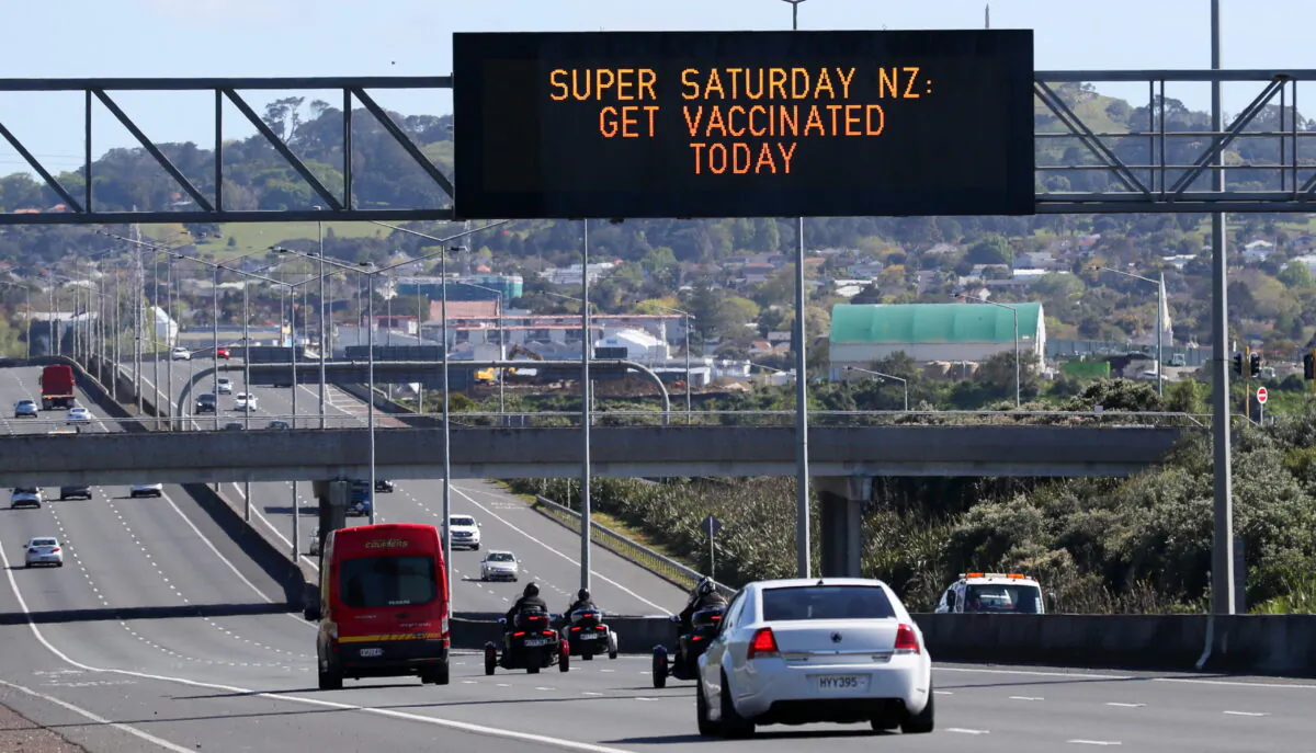 A sign on an Auckland motorway urges people to get vaccinated at a COVID-19 vaccination clinic during a single-day vaccination drive, aimed at significantly increasing the percentage of vaccinated people in the country, in Auckland, New Zealand, on Oct. 16, 2021. (Simon Watts/Reuters)