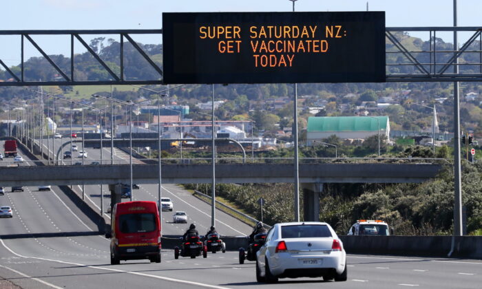 A sign on an Auckland motorway urges people to get vaccinated at a COVID-19 vaccination clinic during a single-day vaccination drive, aimed at significantly increasing the percentage of vaccinated people in the country, in Auckland, New Zealand, on Oct. 16, 2021. (Simon Watts/Reuters)