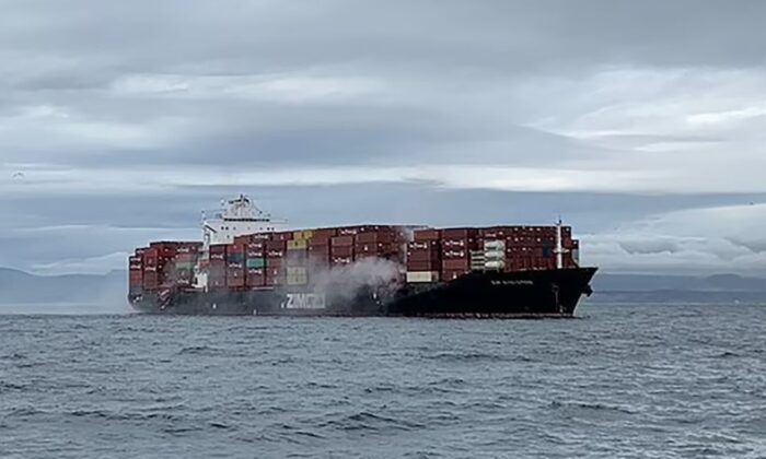 Smoke rises from the container ship Zim Kingston, burning from a fire on board, off the coast of Victoria, British Columbia, on Oct. 23, 2021. (Canadian Coast Guard / Reuters)