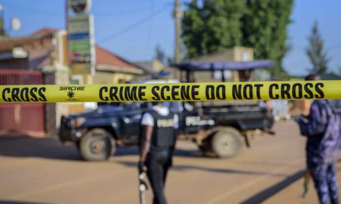 Police secure a road leading to the scene of an explosion in the Komamboga suburb of the capital Kampala, Uganda, on Oct. 24, 2021. (Nicholas Bamulanzeki/AP Photo)