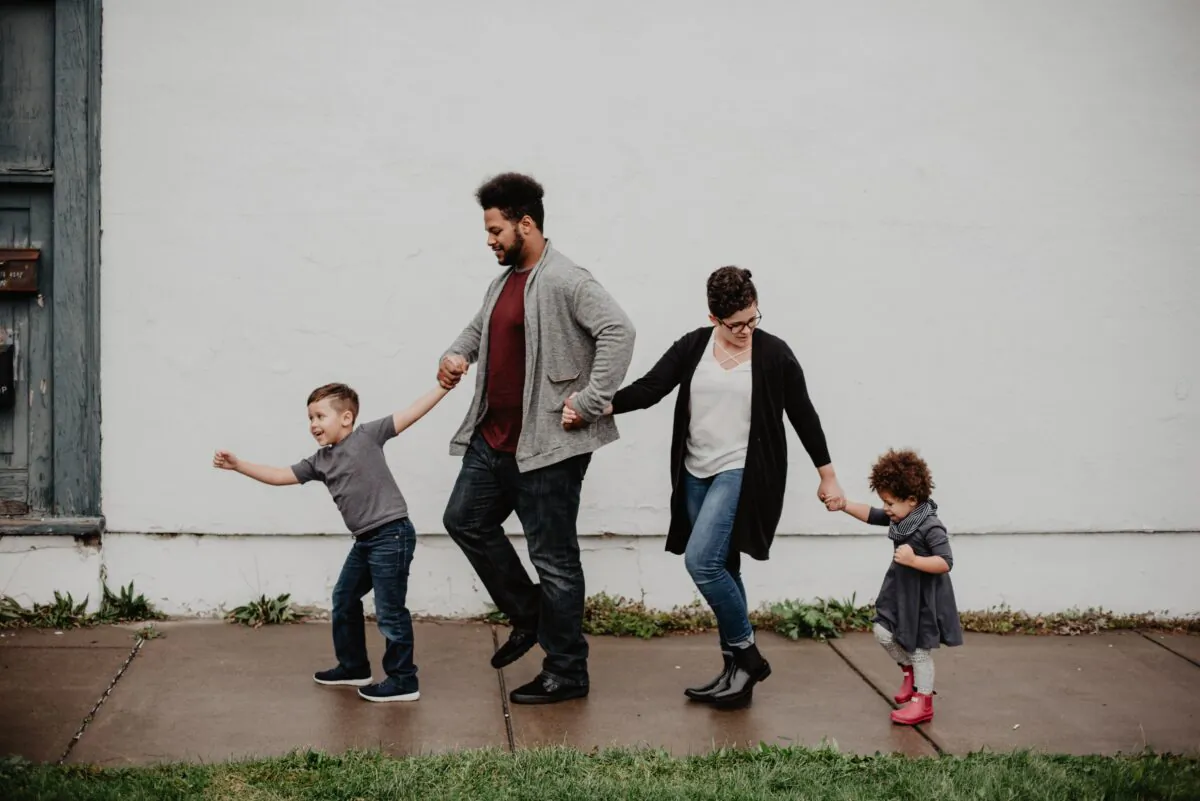 A family of four is walking on the street. (Emma Bauso/Pexels)
