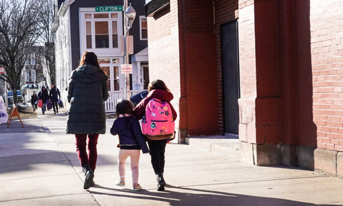 A mom picks up her children at school in Chicago on March 1, 2021. (Scott Olson/Getty Images)