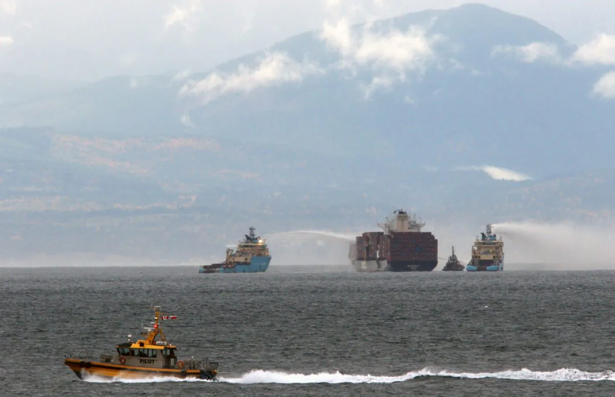 Ships work to control a fire onboard the MV Zim Kingston about 8 kilometers (5 miles) from the shore in Victoria, British Columbia, Canada, on Oct. 24, 2021. (Chad Hipolito/The Canadian Press via AP)
