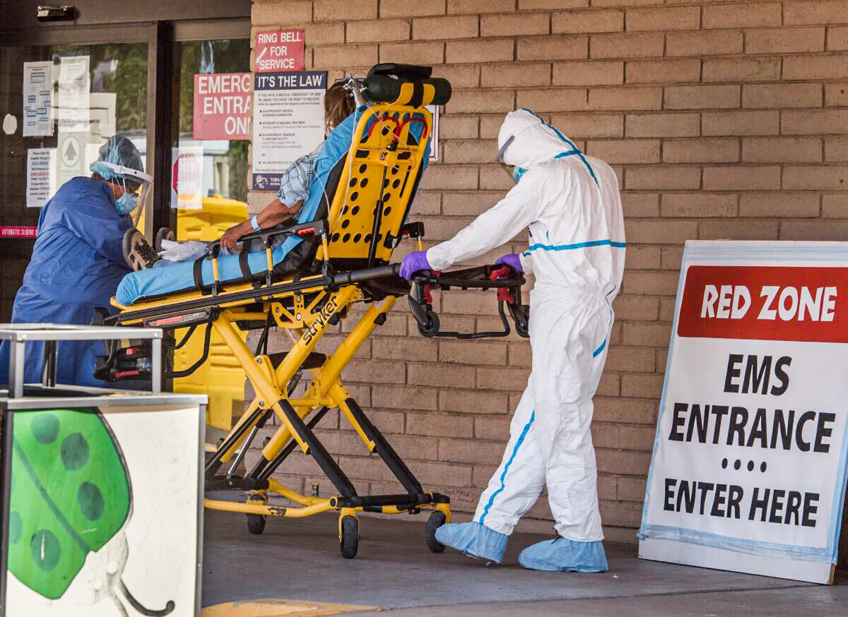 A patient is taken from an ambulance to the emergency room of a hospital in the Navajo Nation town of Tuba City during the 57-hour curfew, imposed to try to stop the spread of the COVID-19 virus through the Navajo Nation, in Arizona on May 24, 2020. (Mark Ralston/AFP via Getty Images)