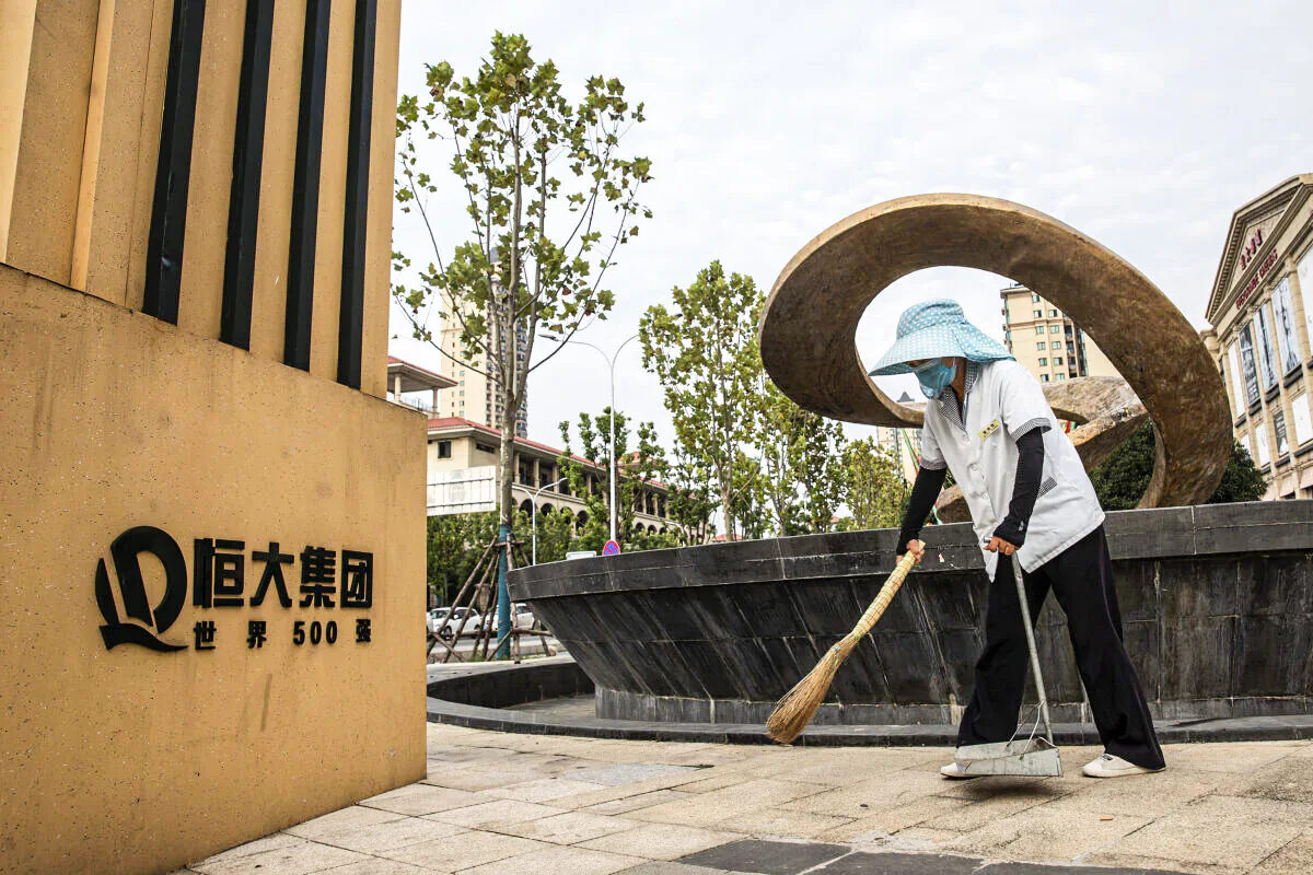 A cleaner sweeps in Evergrande City on Sept. 24, 2021, in Wuhan, Hubei Province, China. Evergrande, China's largest property developer, is facing a liquidity crisis with total debts of around $300 billion. The problems faced by the company could impact China’s economy, and the global economy at large.（Getty Images)