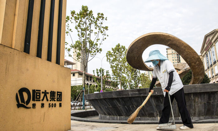 A cleaner sweeps in Evergrande City on Sept. 24, 2021, in Wuhan, Hubei Province, China. Evergrande, China's largest property developer, is facing a liquidity crisis with total debts of around $300 billion. The problems faced by the company could impact China’s economy, and the global economy at large.（Getty Images)