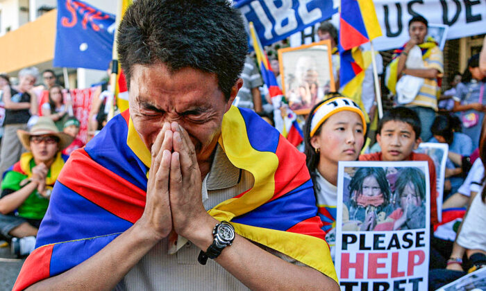 Pro-Tibetan demonstrators pray for human rights in Tibet during a protest outside the Chinese consulate in Sydney, Australia, on March 18, 2008. (Anoek De Groot/AFP via Getty Images)