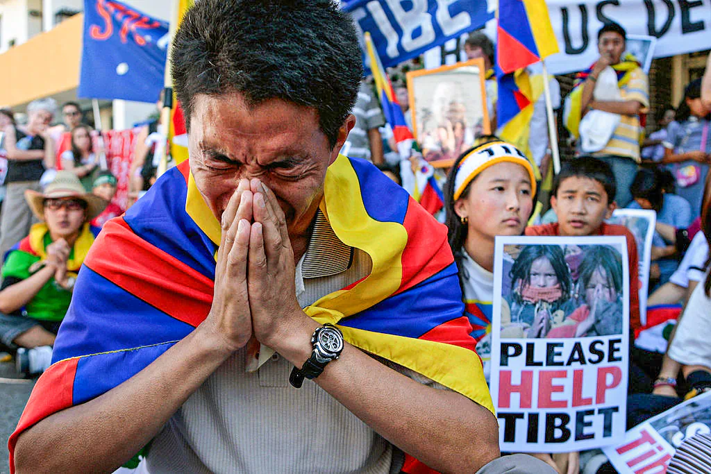 Pro-Tibetan demonstrators pray for human rights in Tibet during a protest outside the Chinese consulate in Sydney, Australia, on March 18, 2008. (Anoek De Groot/AFP via Getty Images)