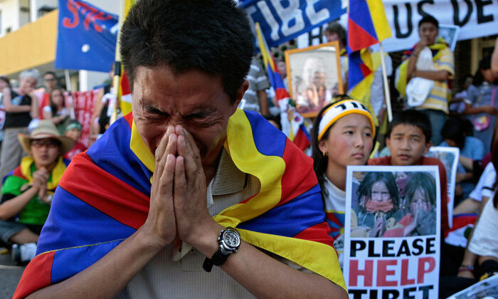Pro-Tibetan demonstrators pray for human rights in Tibet during a protest outside the Chinese consulate in Sydney, Australia, on March 18, 2008. (Anoek De Groot/AFP via Getty Images)