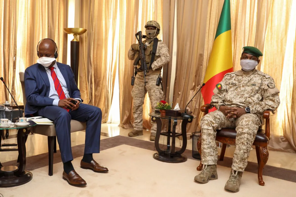 Kenya's Ambassador to the U.N. Martin Kimani, from Kenya (L) leads a United Nations Security Council mission meeting with Transition President Col. Assimi Goita (R) in Bamako, Mali, on Oct. 24, 2021. (Harandane Diko/AP Photo)