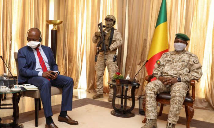 Kenya's Ambassador to the U.N. Martin Kimani, from Kenya (L) leads a United Nations Security Council mission meeting with Transition President Col. Assimi Goita (R) in Bamako, Mali, on Oct. 24, 2021. (Harandane Diko/AP Photo)