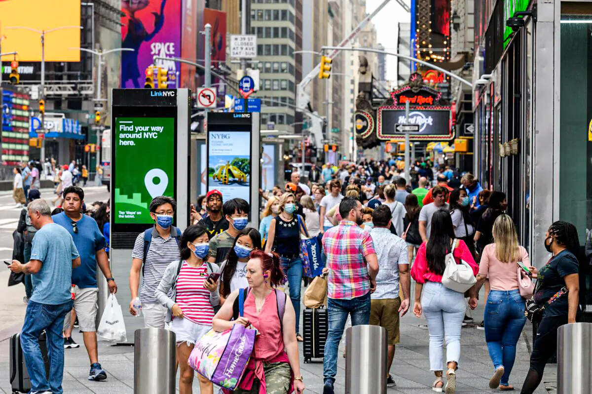 People walk through Times Square in New York City on July 13, 2021. (Angela Weiss/AFP via Getty Images)