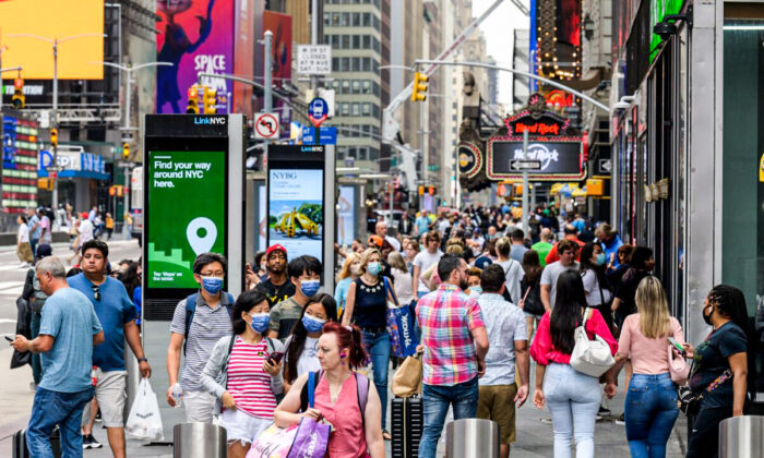 People walk through Times Square in New York City on July 13, 2021. (Angela Weiss/AFP via Getty Images)