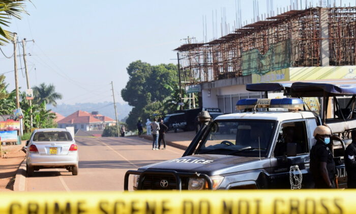 Ugandan police members secure the scene of an explosion in Komamboga, a suburb on the northern outskirts of Kampala, Uganda, on Oct. 24, 2021. (Abubaker Lubows/Reuters)