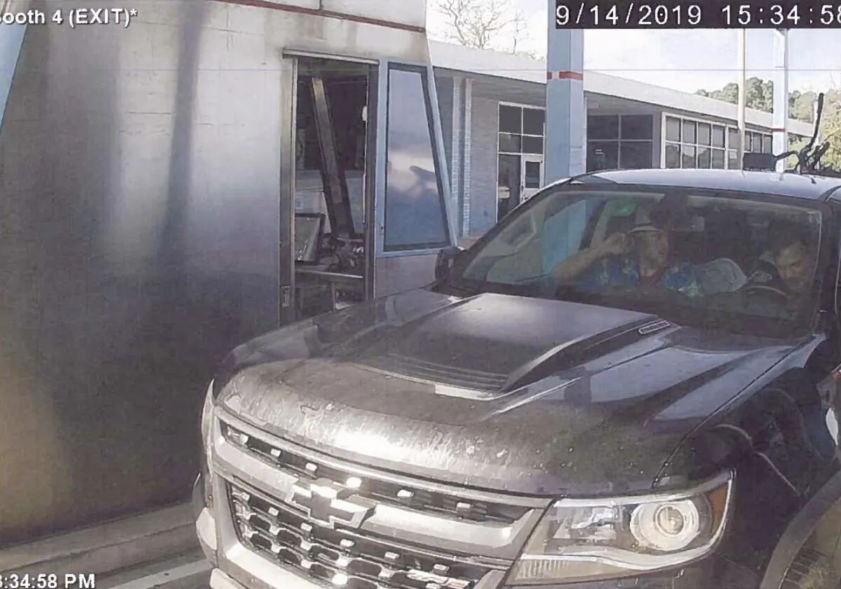 This image taken from video and released in a U.S. Attorney detention memorandum, shows Brian Mark Lemley Jr, driving, and Patrik Mathews, passenger seat, passing through a toll booth near Norfolk, Va., on Sept. 14, 2019. (U.S. Attorney via AP)