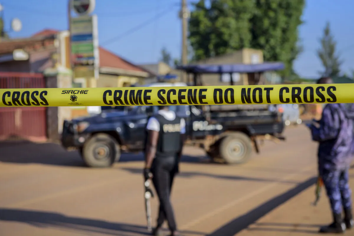 Police secure a road leading to the scene of an explosion in the Komamboga suburb of the capital Kampala, Uganda on Oct. 24, 2021. (Nicholas Bamulanzeki/AP Photo)