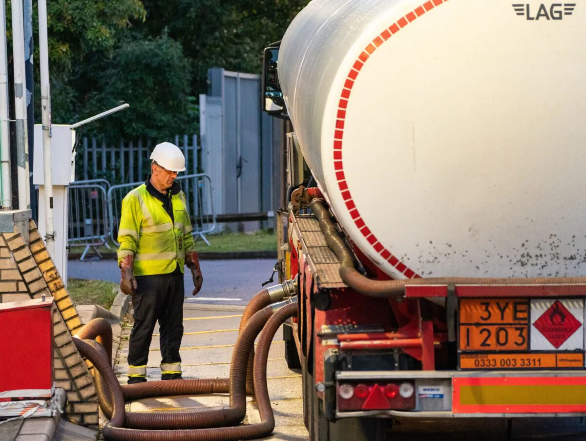 In this undated image, a fuel tanker empties at a petrol station in England during the fuel crisis in autumn of 2021. (Dominic Lipinski/PA)