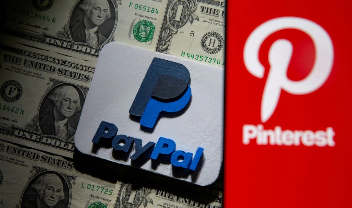 A Pinterest logo is seen on a smartphone placed over U.S. dollar banknotes and a 3D printed PayPal logo in this illustration taken on Oct. 20, 2021. (Dado Ruvic/Illustration/Reuters)