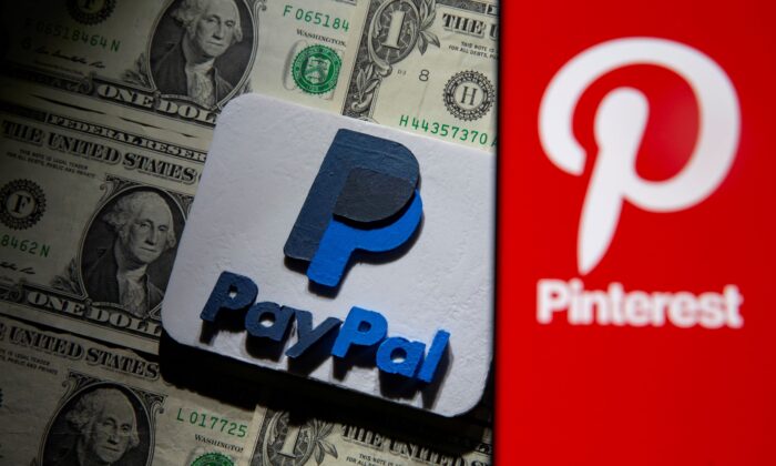 A Pinterest logo is seen on a smartphone placed over U.S. dollar banknotes and a 3D printed PayPal logo in this illustration taken on Oct. 20, 2021. (Dado Ruvic/Illustration/Reuters)