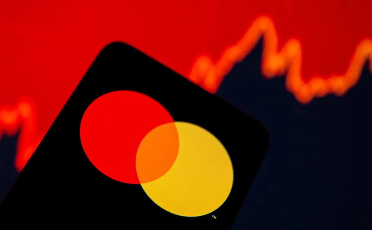 A smartphone with Mastercard logo is seen in front of displayed stock graph in this illustration taken on July 15, 2021. (Dado Ruvic/Illustration/Reuters)