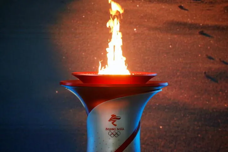 The Olympic flame burns in a cauldron at the ceremony in Beijing, China, on Oct. 20, 2021. (Tingshu Wang/Reuters)