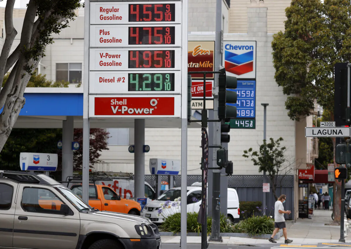 Gas prices nearing $5.00 per gallon are displayed at Chevron and Shell stations on July 12, 2021, in San Francisco. (Justin Sullivan/Getty Images)