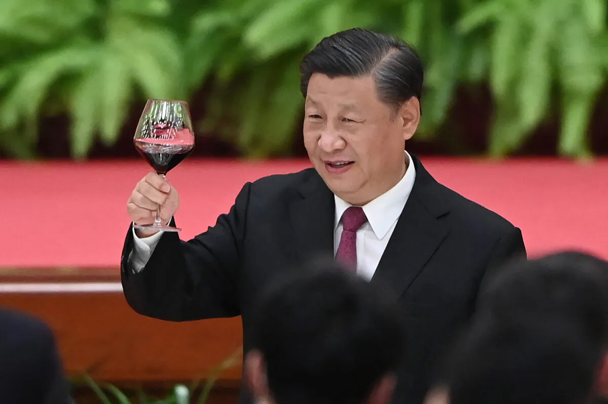 Chinese leader Xi Jinping raises his glass after a speech by Premier Li Keqiang at a reception at the Great Hall of the People in Beijing on the eve of the 72nd anniversay of the regime's takeover of China on Sept. 30, 2021. (Greg Baker/AFP via Getty Images)