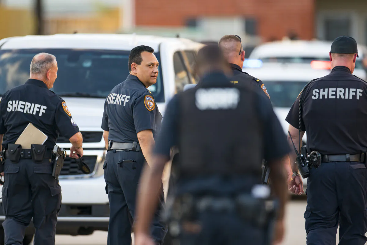 Harris County Sheriff Ed Gonzalez walks back to the scene where, according to Gonzalez, three juveniles were found living alone along with the skeletal remains of another person, possibly a juvenile, in a third floor apartment at the CityParc II at West Oaks Apartments in west Houston on Oct. 24, 2021. (Mark Mulligan/Houston Chronicle via AP)