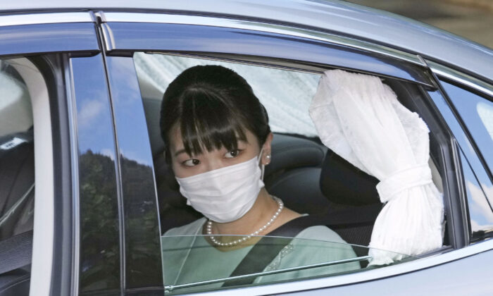 Japan's Princess Mako in a car leaves her home in Akasaka Estate in Tokyo on Oct. 26, 2021. (Chika Oshima/Kyodo News via AP)