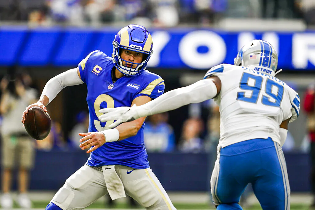 Los Angeles Rams quarterback Matthew Stafford, left, scrambles under pressure from Detroit Lions linebacker Julian Okwara (99) during the second half of an NFL football game Sunday, Oct. 24, 2021, in Inglewood, Calif. (AP Photo/Marcio Jose Sanchez)
