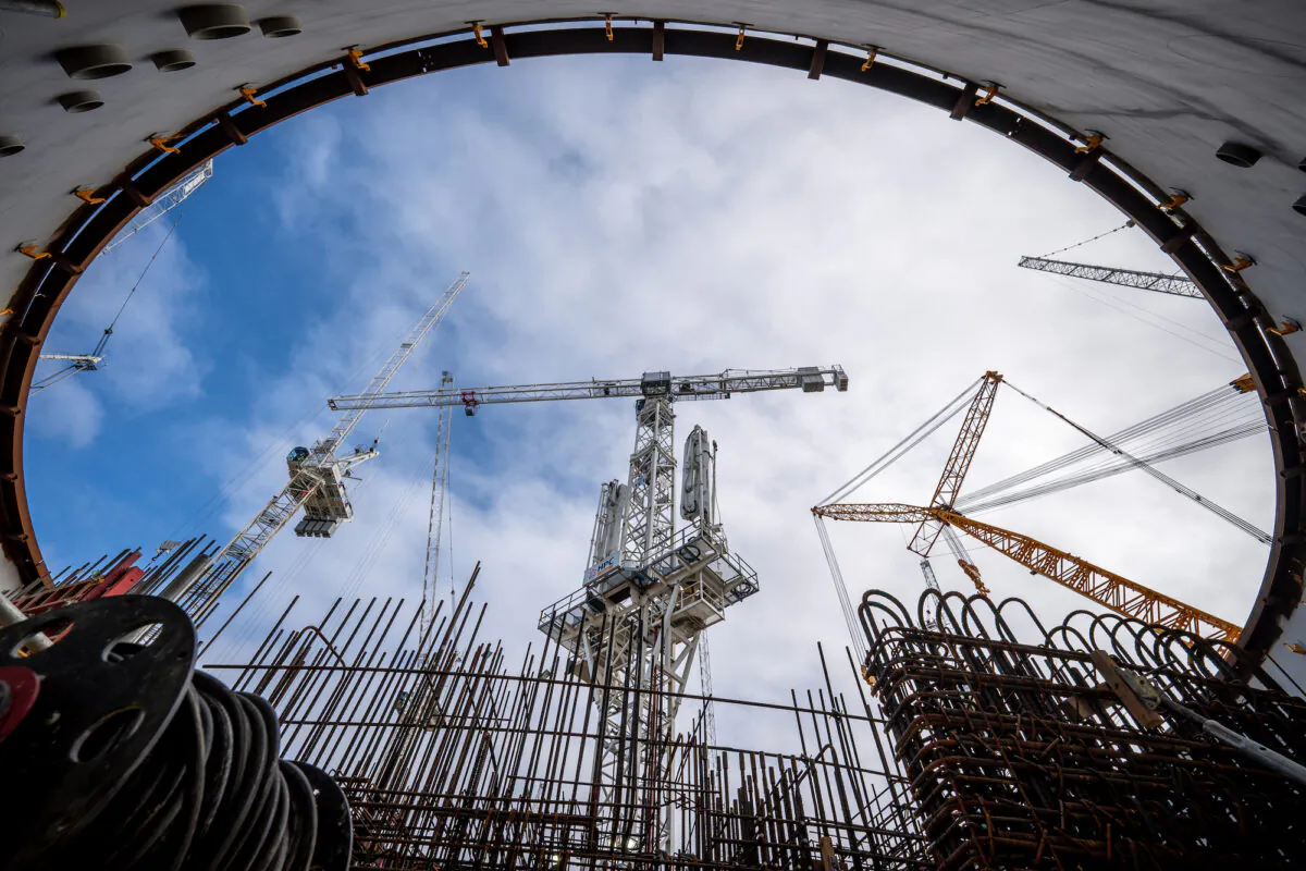 A crane moves building materials into the circular reinforced concrete and steel home of a reactor at Nuclear Island 1, at Hinkley Point C nuclear power plant near Bridgwater in Somerset, England on Sept. 23, 2021. (Ben Birchall/PA)